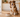 Dog beside a bowl of wet food in a warm, minimalist kitchen